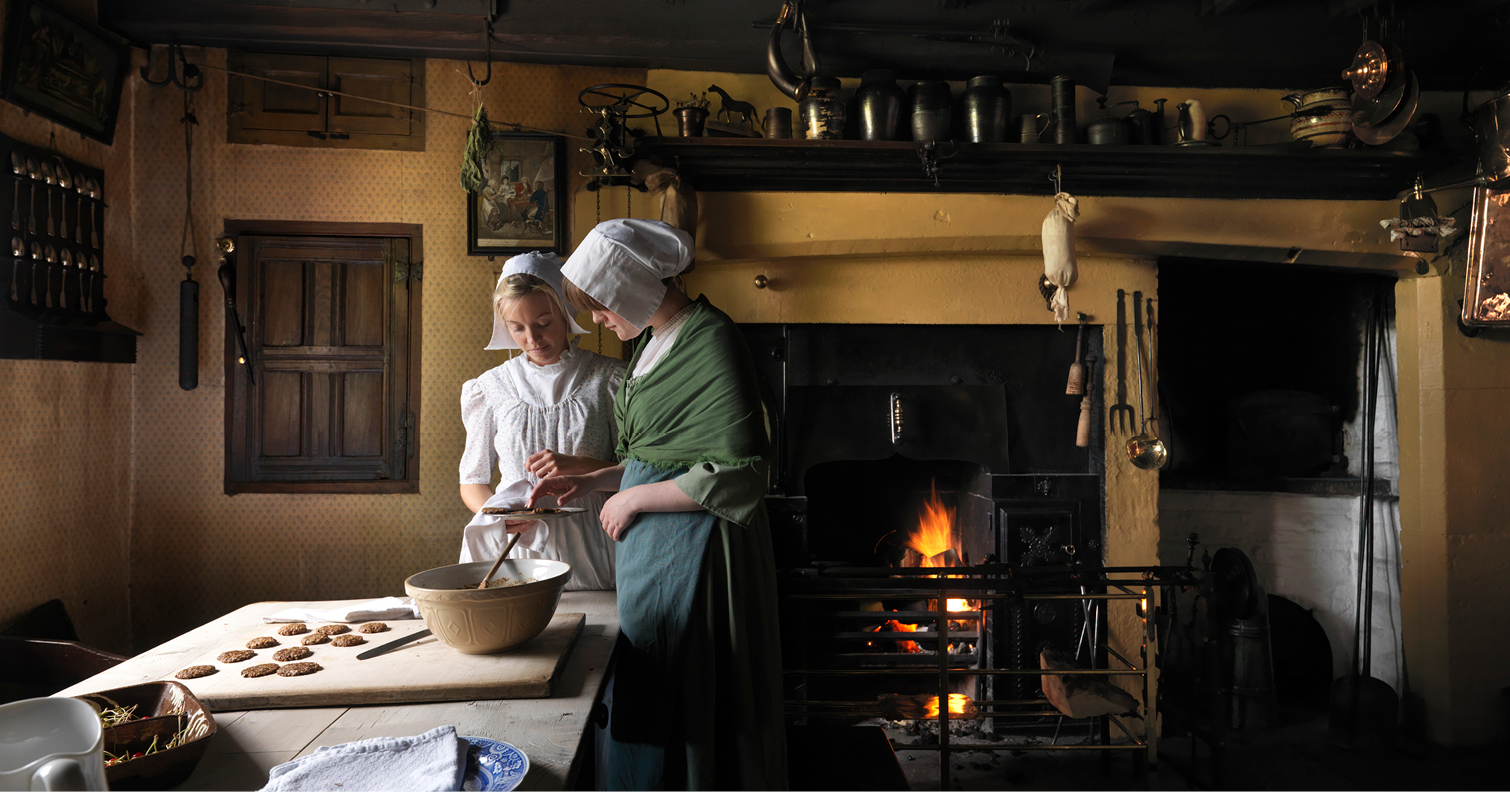 two women baking inside Pockerley Old Hall, Beamish Museum 